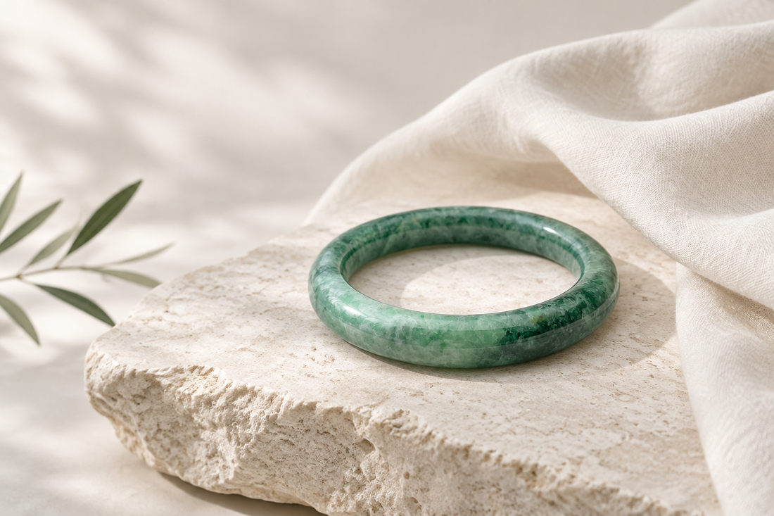 Illustrative modern still life of a rich green Kazakh jadeite bangle inspired by a distinct current ZHAUHAR listing, not a historic artifact